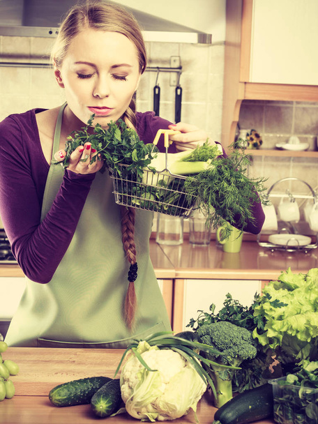 Woman in kitchen having vegetables holding shopping basket - Fotografie, Obrázek