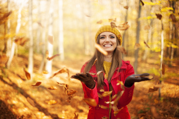 Happy woman throwing leaves - Photo, Image
