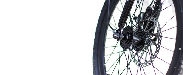 Close up wheel and chain of mountain biking. Landscape view of disc break system and front Derailleur of moutain bike. bicycle parts titanium color and frame aluminium. Shift lever and brake lever. - Photo, Image