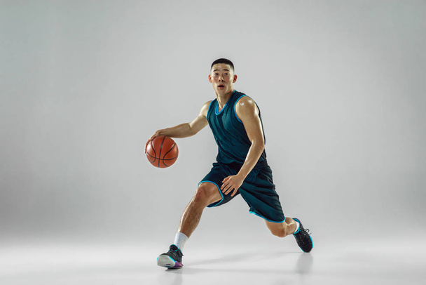 Young basketball player training isolated on white studio background - Fotoğraf, Görsel