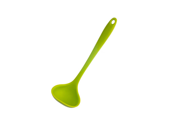 Single silicone green small plastic ladle close up shot isolated - 写真・画像
