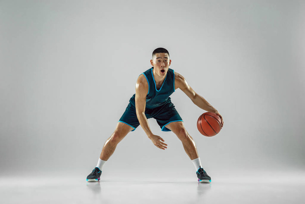 Young basketball player training isolated on white studio background - Photo, Image