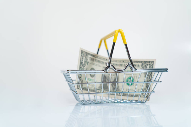 money in a supermarket basket concept of payment for goods - Φωτογραφία, εικόνα