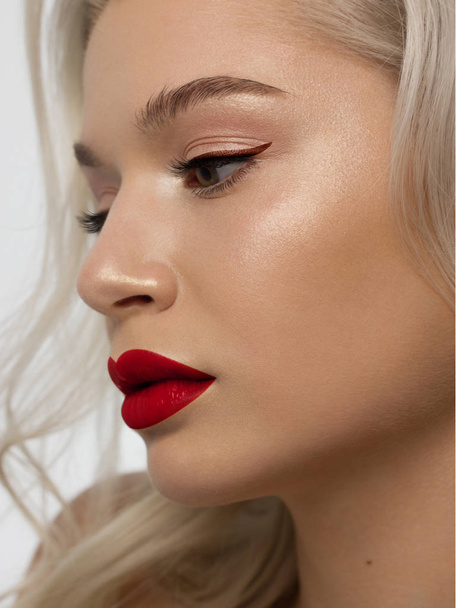 Closeup portrait of a woman with developing straight hair. Sweet tender young girl blonde. Natural lipstick, transparent clean skin. Skin care natural cosmetics in the spa salon or cosmetology. - Foto, Bild