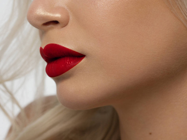 Sexual full lips. Natural gloss of lips and woman's skin. The mouth is closed. Increase in lips, cosmetology. red lipstick. Open mouth and with teeth. blonde hair. - Photo, image