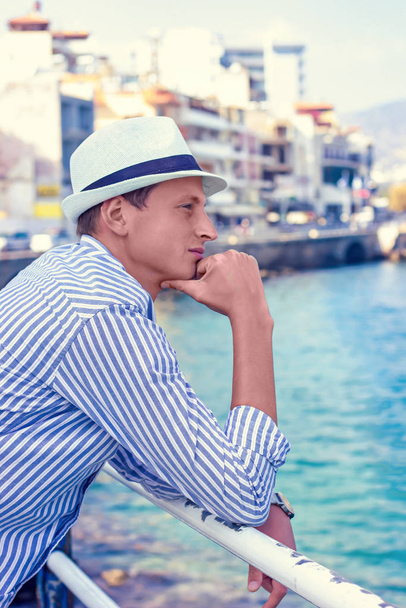 young man fashion photoshoot at the beach sunny day - 写真・画像