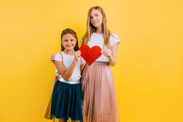 Happy family, mother and daughter with paper hearts in their han - Foto, Bild