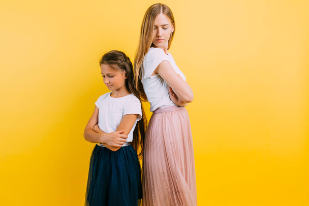 Offended mother and daughter standing with their backs to each o - Photo, image