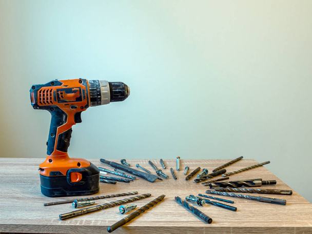 Electric drill and construction tool on the wooden table. - Photo, Image
