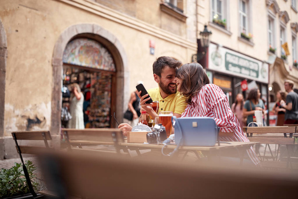 beautiful young couple having a good time on street cafe in prag - Фото, зображення