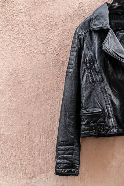 Black leather jacket on pink wall - Zdjęcie, obraz