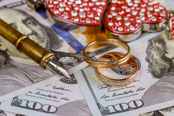 Marriage contract gold wedding rings so close and a dollar, love and money - Photo, Image