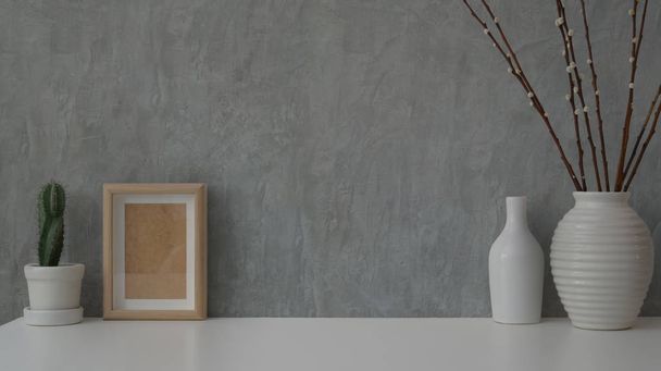 Close up view of minimal workspace on white table with grey loft wall - Photo, Image