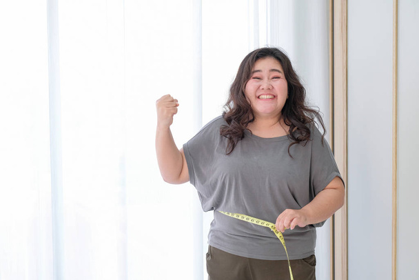 Asian obese women are happy because of size reduction after chec - Foto, Bild