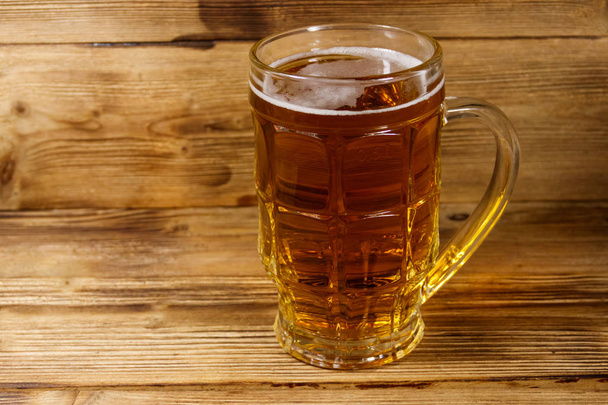 Mug of beer on a wooden table - Foto, immagini