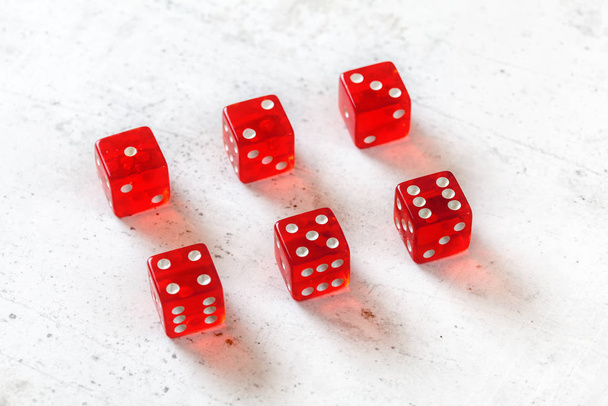 Red translucent craps dices on white board, showing numbers from - Photo, image