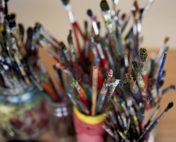 A lot dirty artist paint brushes in a bucket - Photo, Image