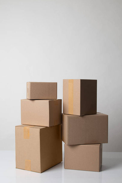 Pile of various size taped up  cardboard boxes - Fotó, kép