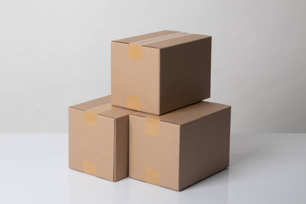 Pile of three  taped up  cardboard boxes - Zdjęcie, obraz