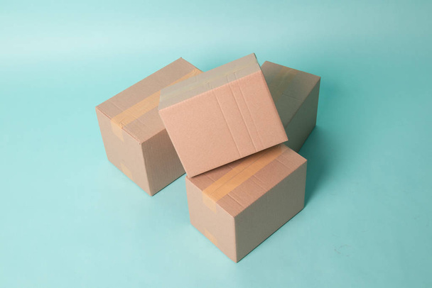 Pile of three  taped up  cardboard boxes - Фото, изображение