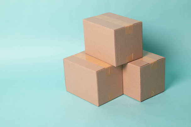 Pile of three  taped up  cardboard boxes - Фото, изображение