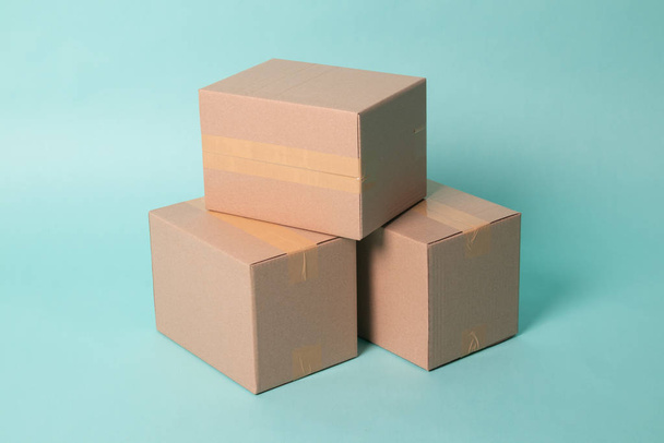 Pile of three  taped up  cardboard boxes - Valokuva, kuva