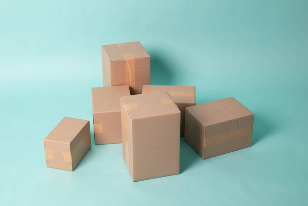 Pile of various size taped up  cardboard boxes - Fotografie, Obrázek