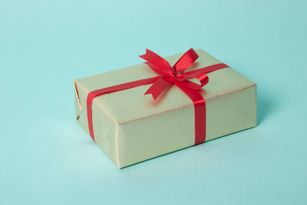 Golden gift box with red ribbon - Fotó, kép