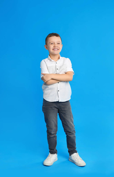 Portrait of cute little boy on blue background - Fotó, kép