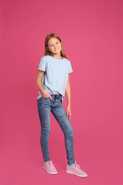 Full length portrait of preteen girl on pink background - Photo, Image