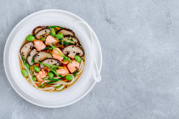 Salmon Noodle Soup with shiitake mushrooms, edamame beans and green onion. - Photo, Image