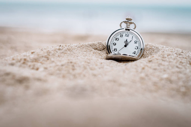 retro pocket watch on the beach - Фото, изображение