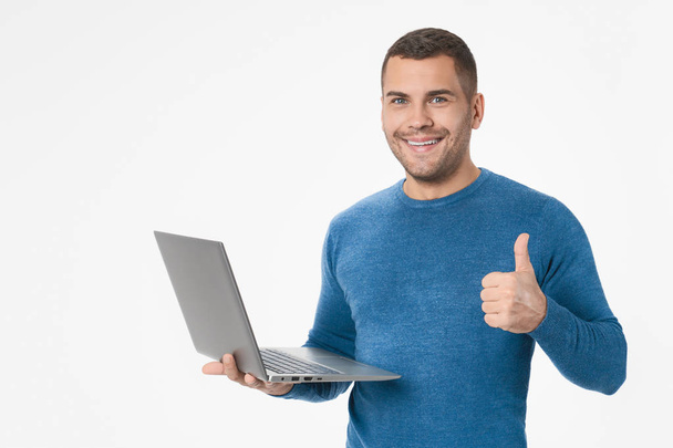Portrait of smiling happy man with laptop and thumb up isolated on white - Foto, Imagem