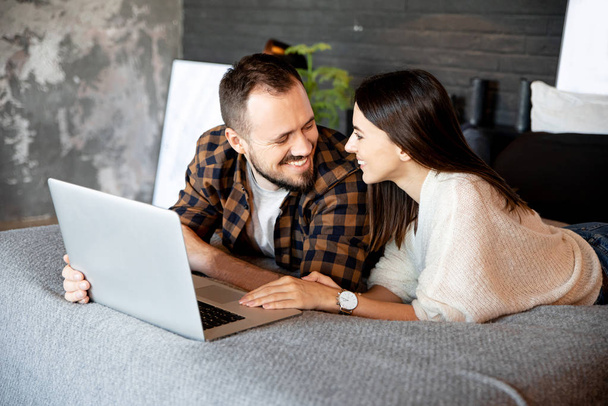 Close portrait of couple with laptop at home - 写真・画像