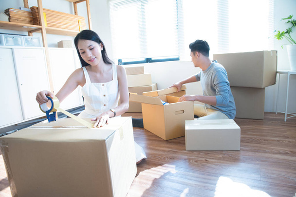 startup small business owner at workplace. freelance asian man and asian woman seller check product order, packing goods for delivery to customer. Online selling, e-commerce, shipping concept. - Photo, Image