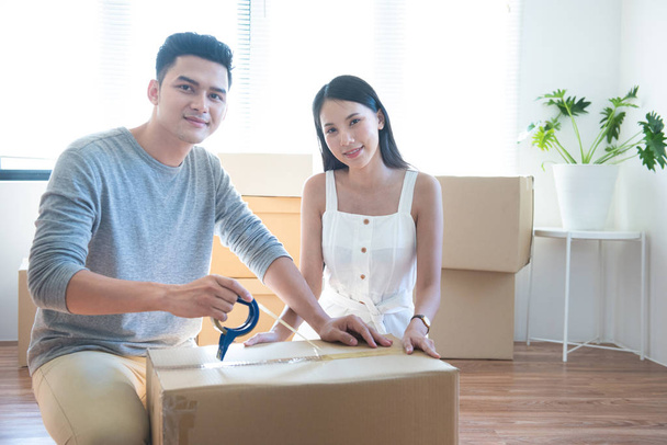 startup small business owner at workplace. freelance asian man and asian woman seller check product order, packing goods for delivery to customer. Online selling, e-commerce, shipping concept. - 写真・画像