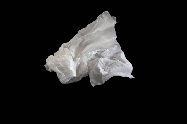 Used screwed paper tissue on dark background. Valueless concept. - Photo, Image