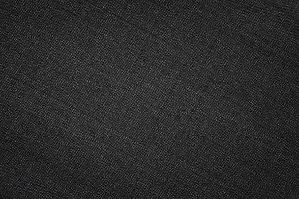 Černá textura tkaniny. Textilní pozadí se známkou - Fotografie, Obrázek