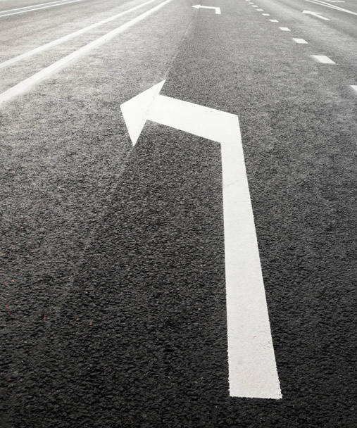 White turn left arrow on the road. - Photo, Image