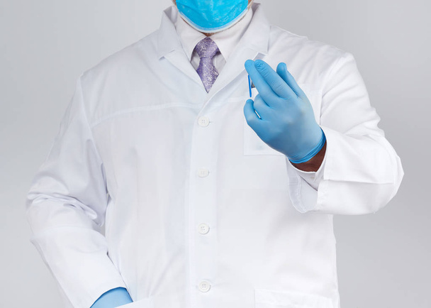 лікар у білому пальто та краватці, одягнений у сині стерильні рукавички на h
 - Фото, зображення