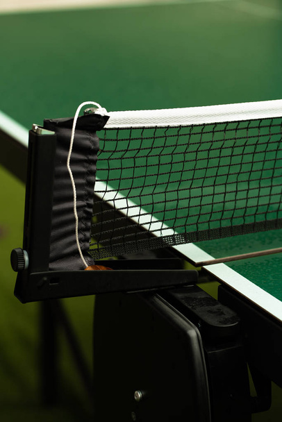 Table Tennis or ping pong rackets and balls on table. Sport concept.Texture of green wooden table,equipment for table tennis sport - 写真・画像