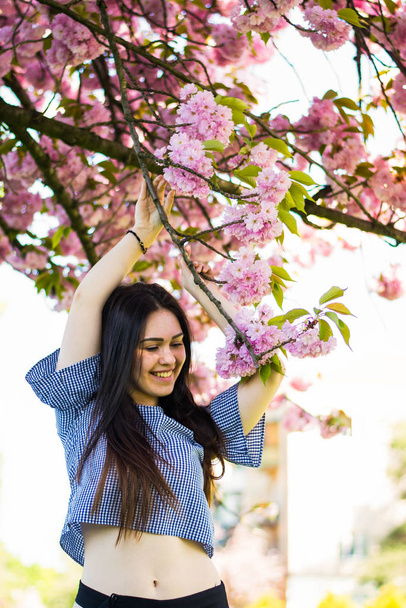 Plus size fashion model in casual clothes, overweight female body in a park outdoors. Spring concept. - Фото, зображення
