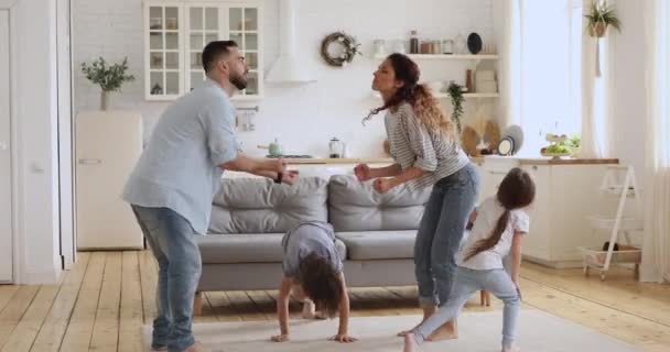 Happy carefree couple dancing together with two little children. - Materiaali, video