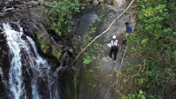 Dobrodružná turistika v tropické Kostarice při slaňování dolů krásný vodopád hluboko v jižních horách země - Záběry, video