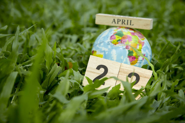 22 April Earth Day on green grass background - Foto, imagen