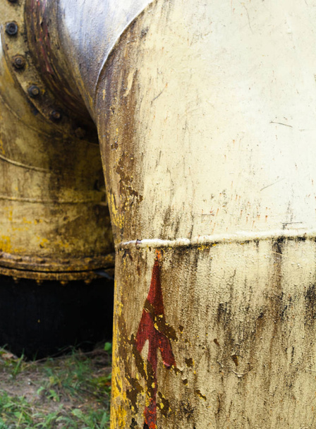 Yellow dirty pipe (tube). Red arrow on the pipe. - Photo, Image