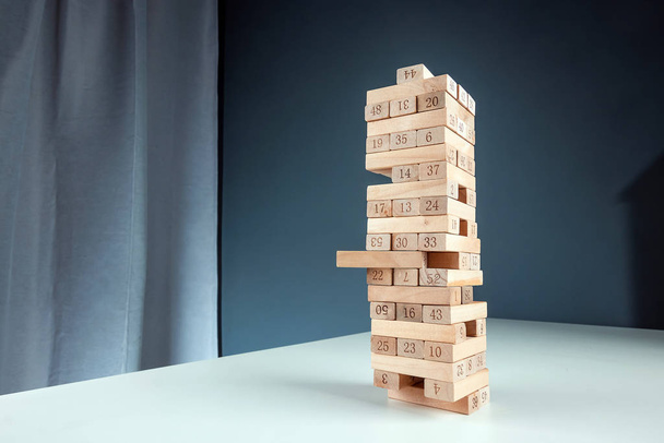 Column game jenga. The concept of a mortgage, investment risks, economic crisis, economic instability. - Zdjęcie, obraz