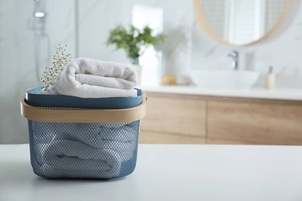Basket with clean soft towels in bathroom. Space for text - Foto, immagini