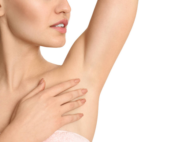 Young woman showing armpit with smooth clean skin on white background, closeup - 写真・画像