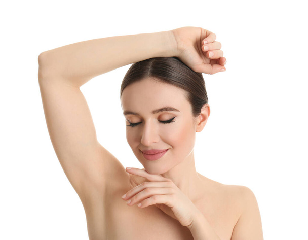 Young beautiful woman showing armpit with smooth clean skin on white background - Фото, зображення